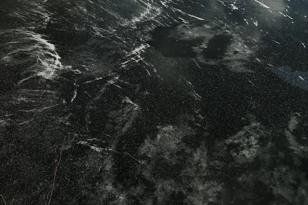 Galaxy quartz slab showcasing deep black tones with scattered white speckles and veins.