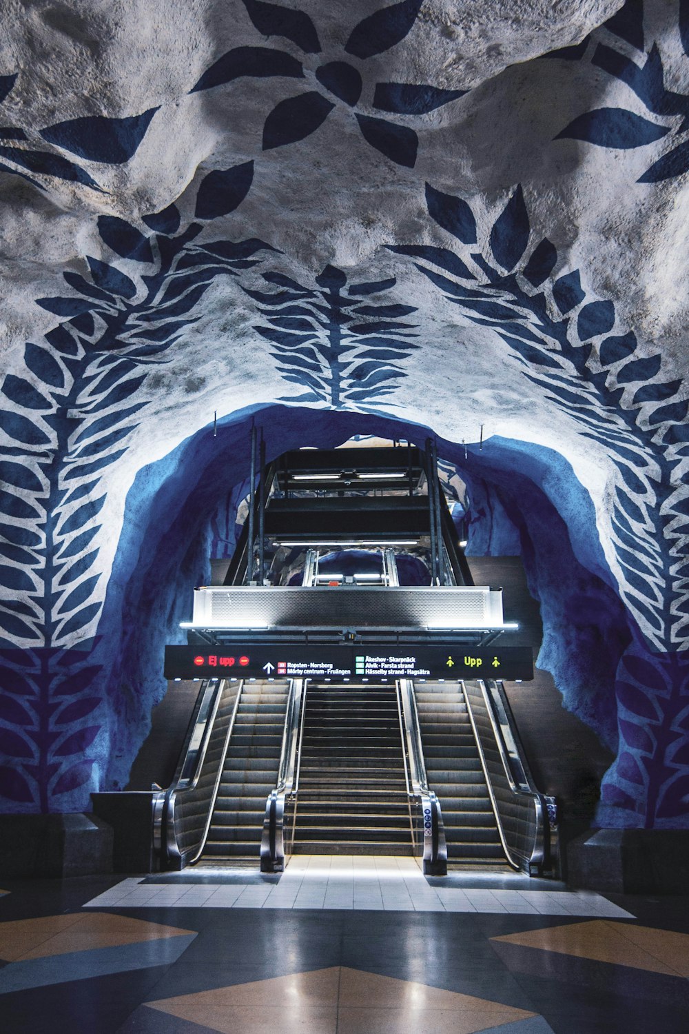 black and gray escalator inside tunnel