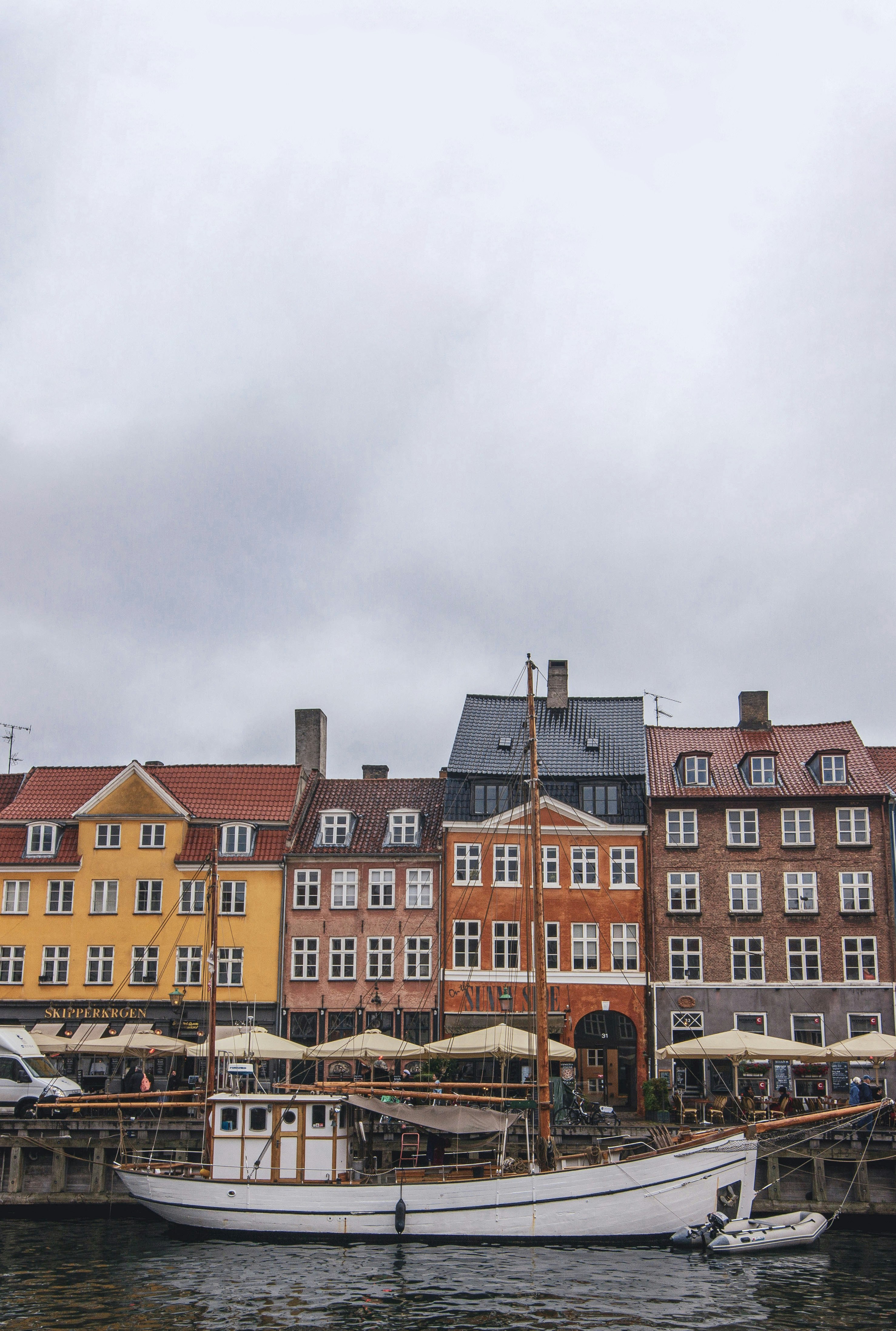 brown and white concrete building under white clouds during daytime