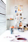 An artistic shot of colorful mood boards pinned on a wall in a cozy studio.
