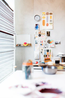 A creative workspace featuring colorful mood boards and branding materials spread out.