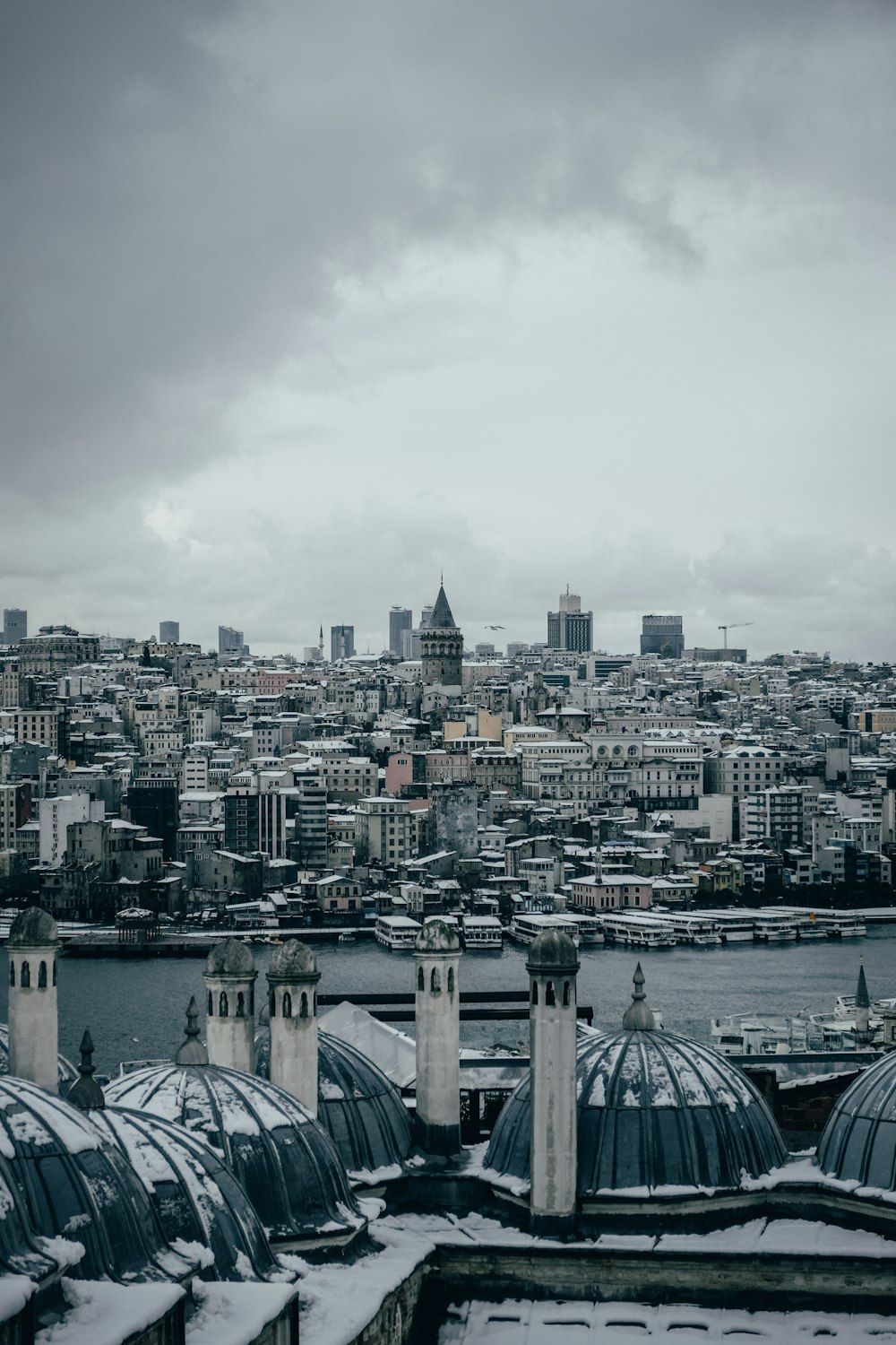 city with high rise buildings under white sky during daytime