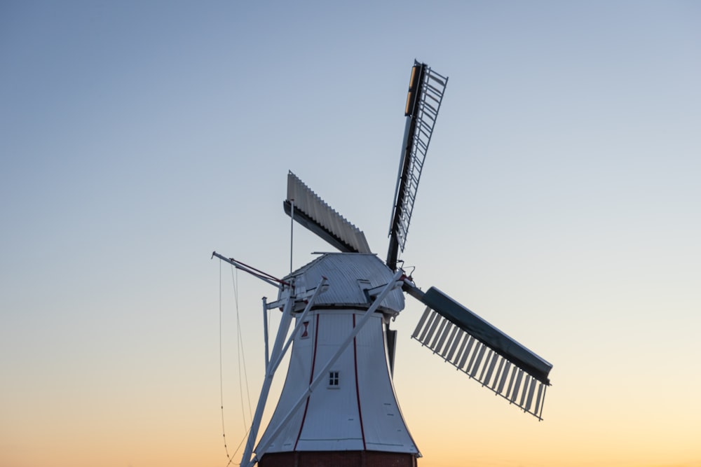 black windmill under blue sky during daytime