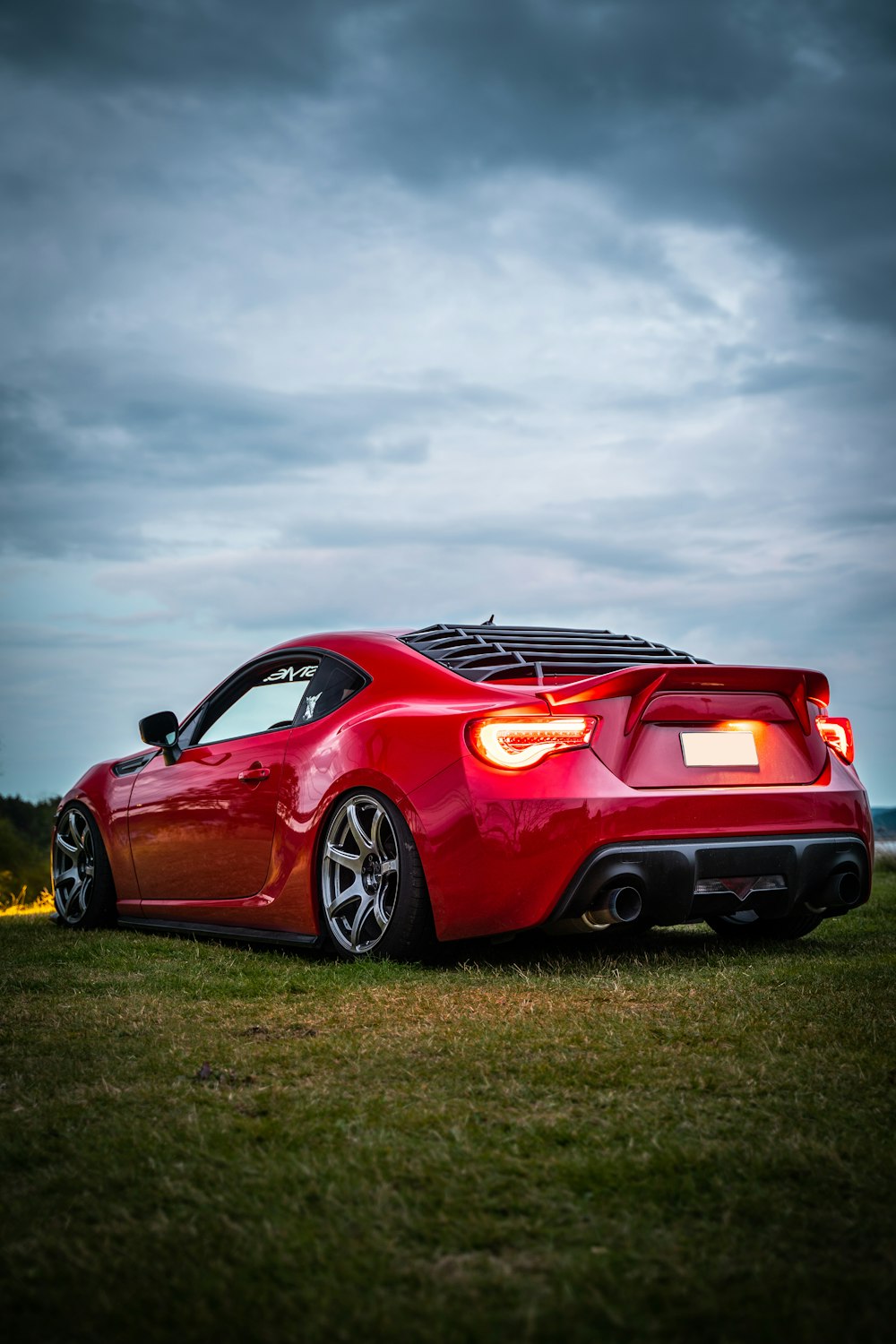 red ferrari 458 italia on green grass field