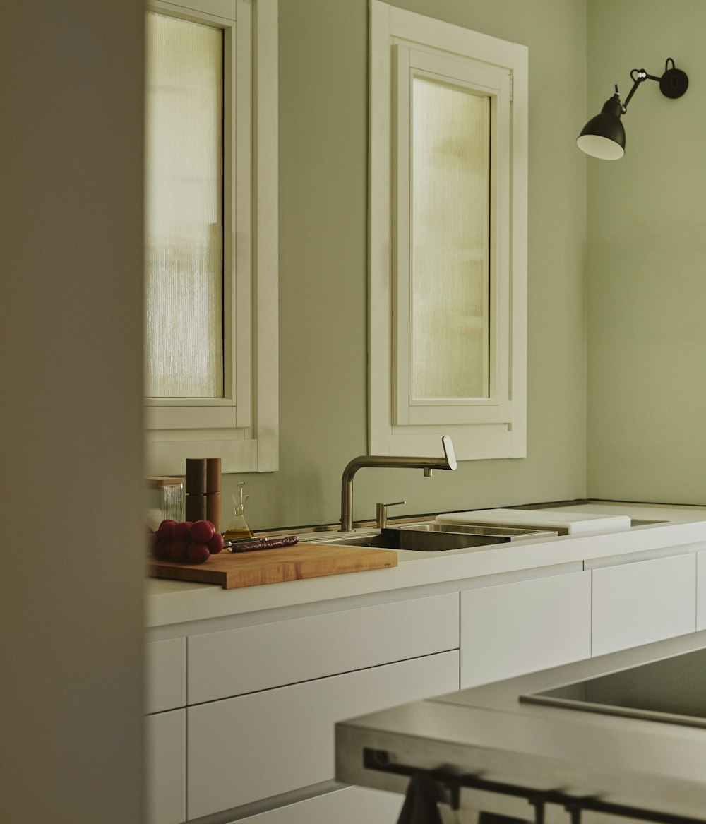 white wooden kitchen cabinet near white wooden framed glass window