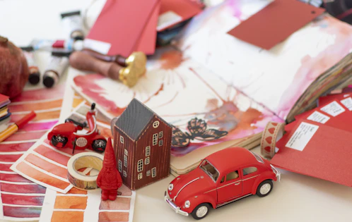 A cozy workspace with colorful children's book drafts and art supplies scattered around.