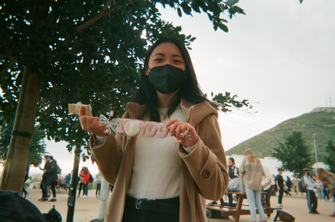 woman in brown coat and black sunglasses