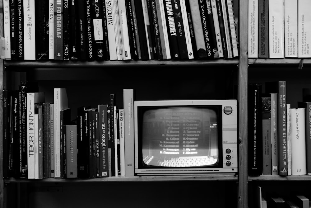 gray crt tv on black wooden shelf