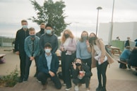 A cheerful group of friends dressed in trendy outfits at a park.