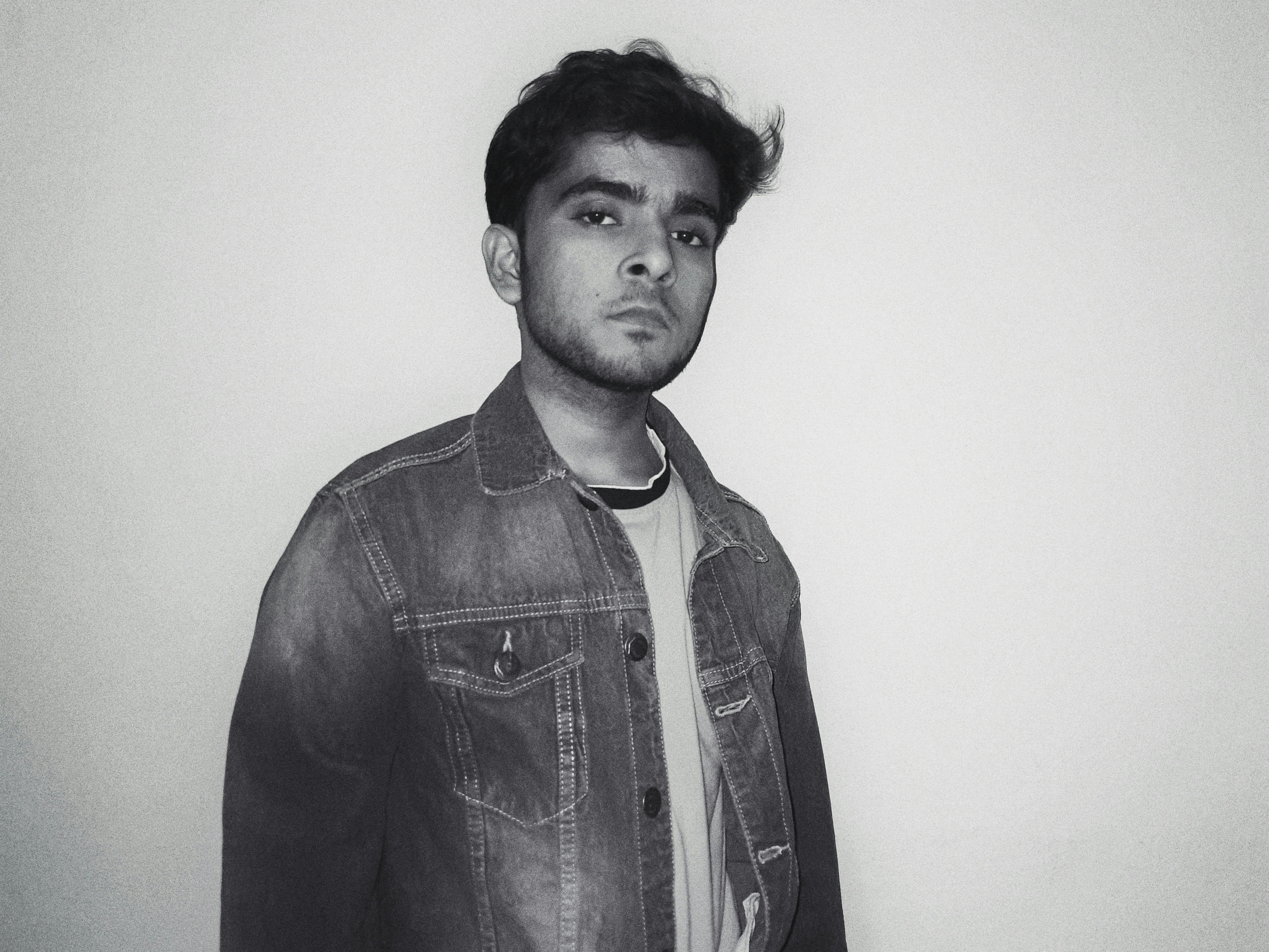 man in black denim button up jacket