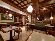 Cozy interior of fritto misto with wooden tables and soft lighting creating a warm atmosphere.