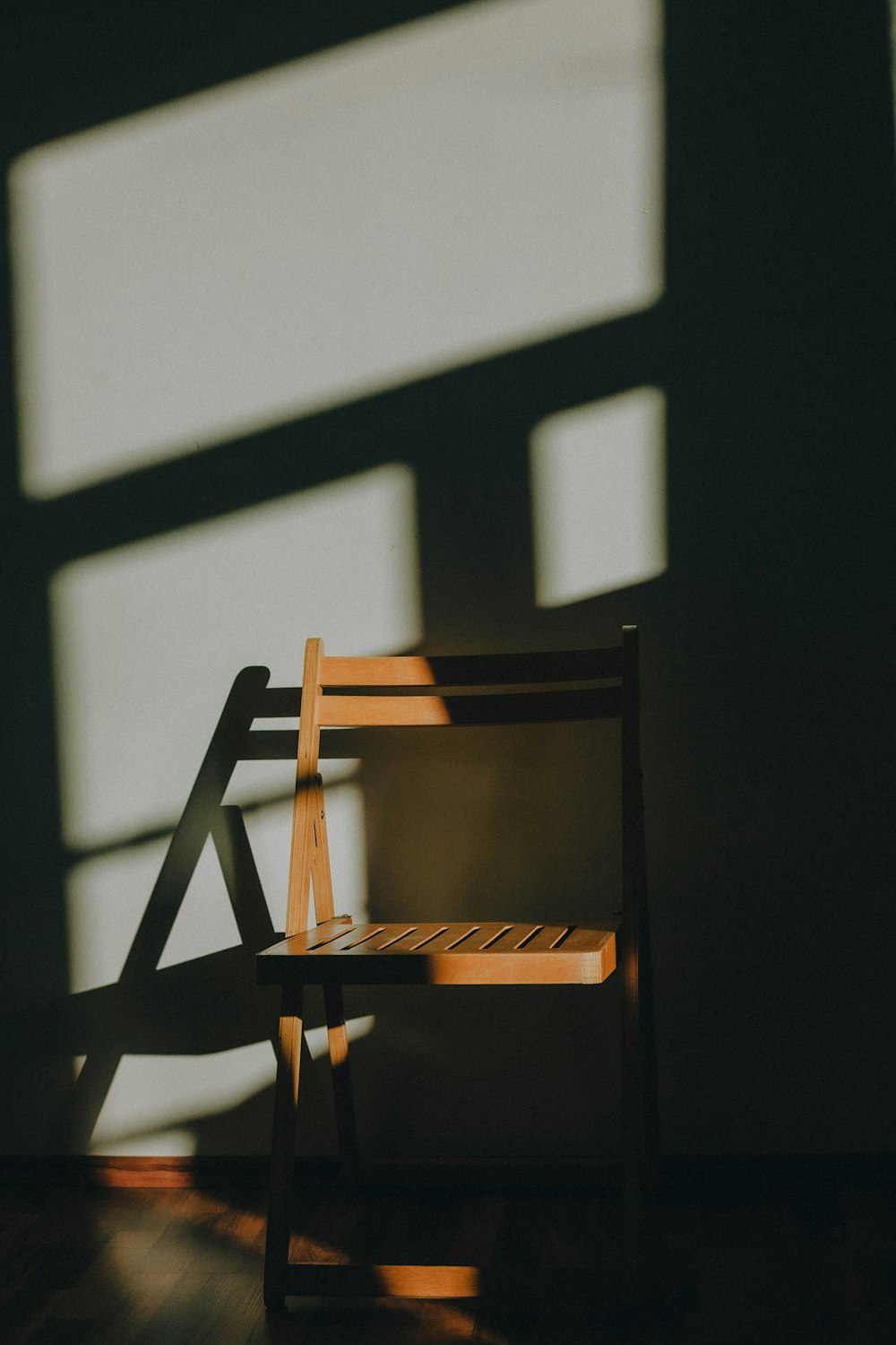 brown wooden chair near white wall