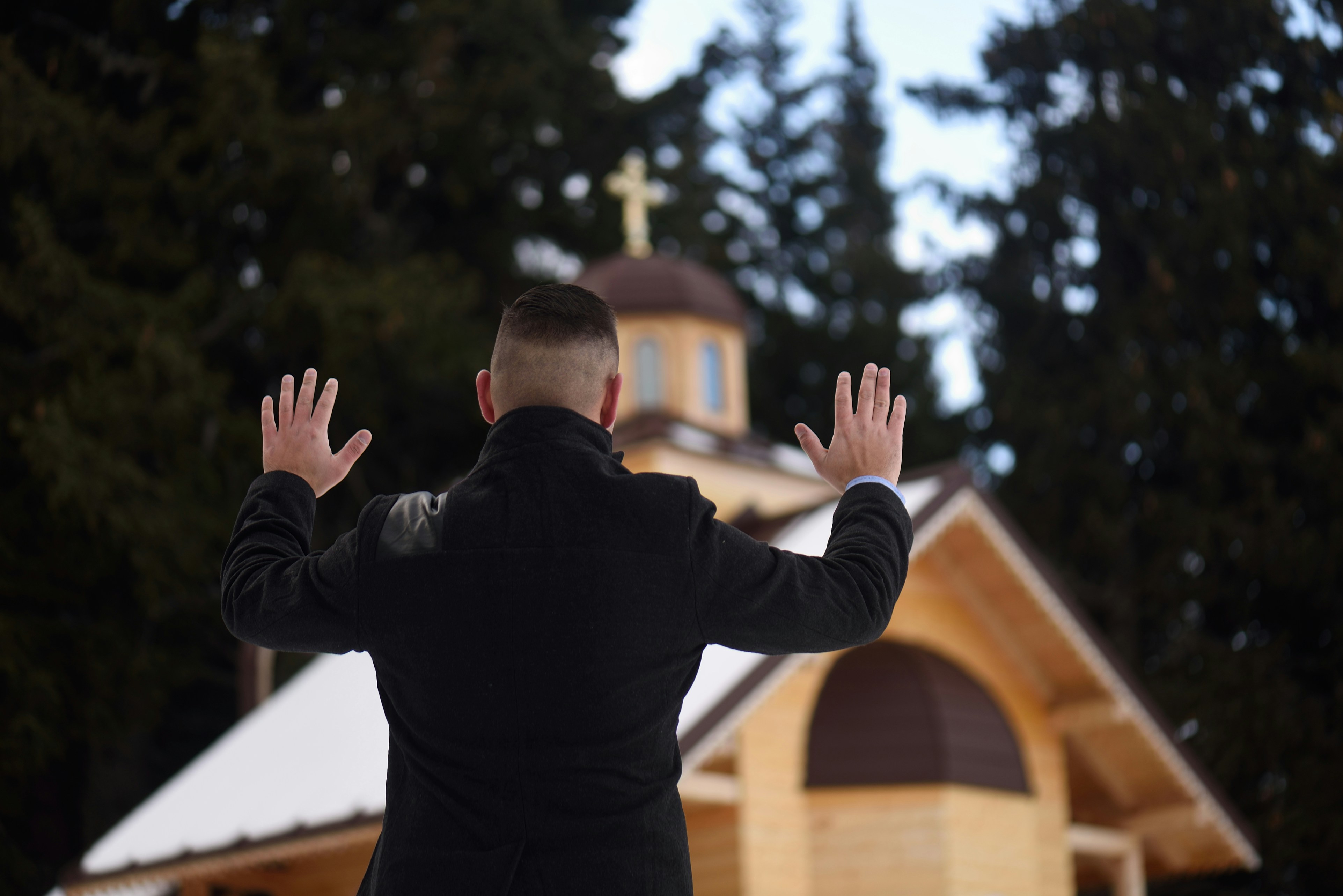 man in black long sleeve shirt raising his hands