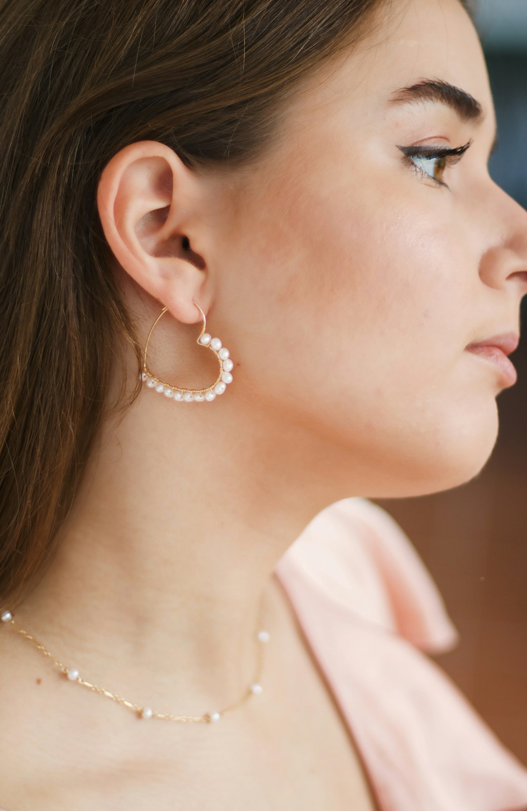 woman wearing silver and white pearl earrings