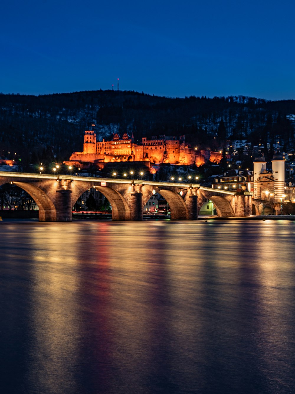 brown concrete bridge over river during night time