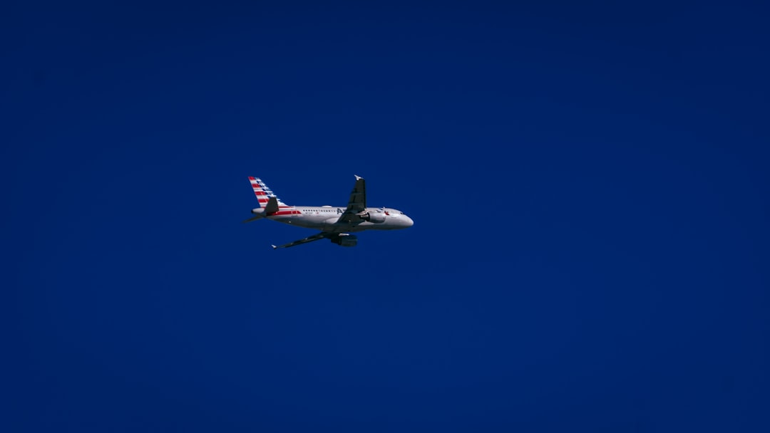 white and red airplane in mid air, 𝕋𝕒𝕜𝕖 𝔽𝕝𝕚𝕘𝕙𝕥 👇😎🥃.