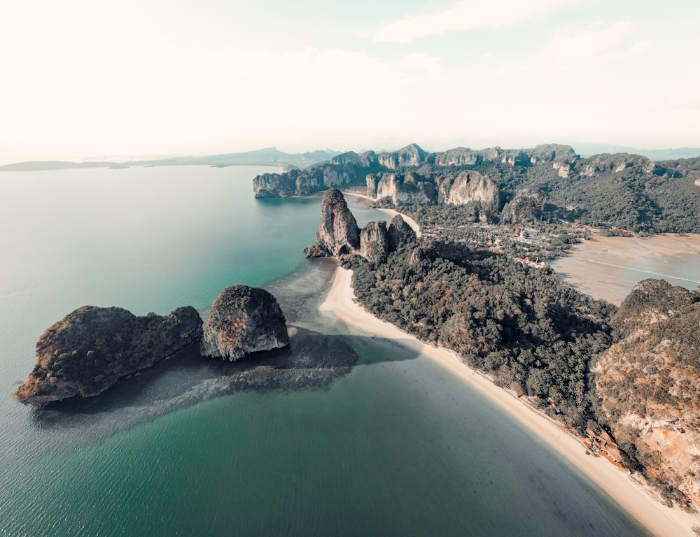 brown rock formation on body of water during daytime