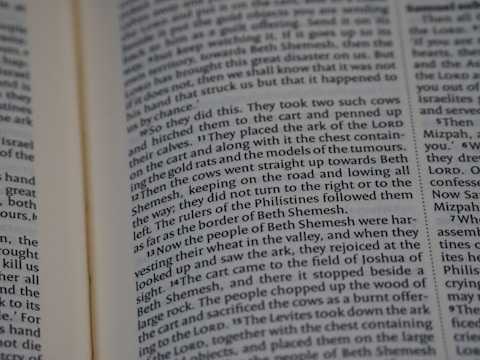A close-up of a page from a book with text arranged in columns. The text is in English and appears to be from a religious or historical book, possibly a Bible or similar scripture.