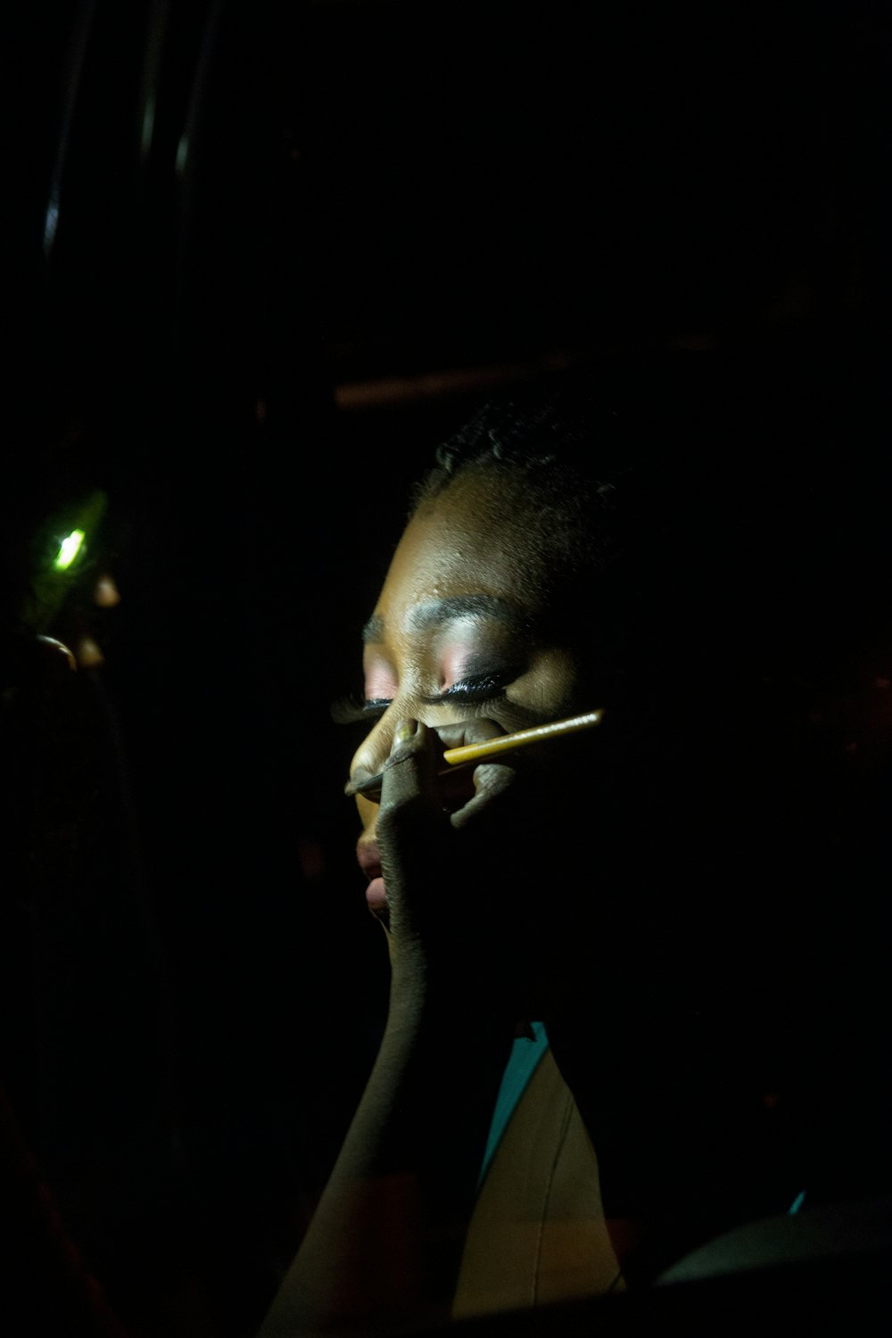 man smoking cigarette in a dark room