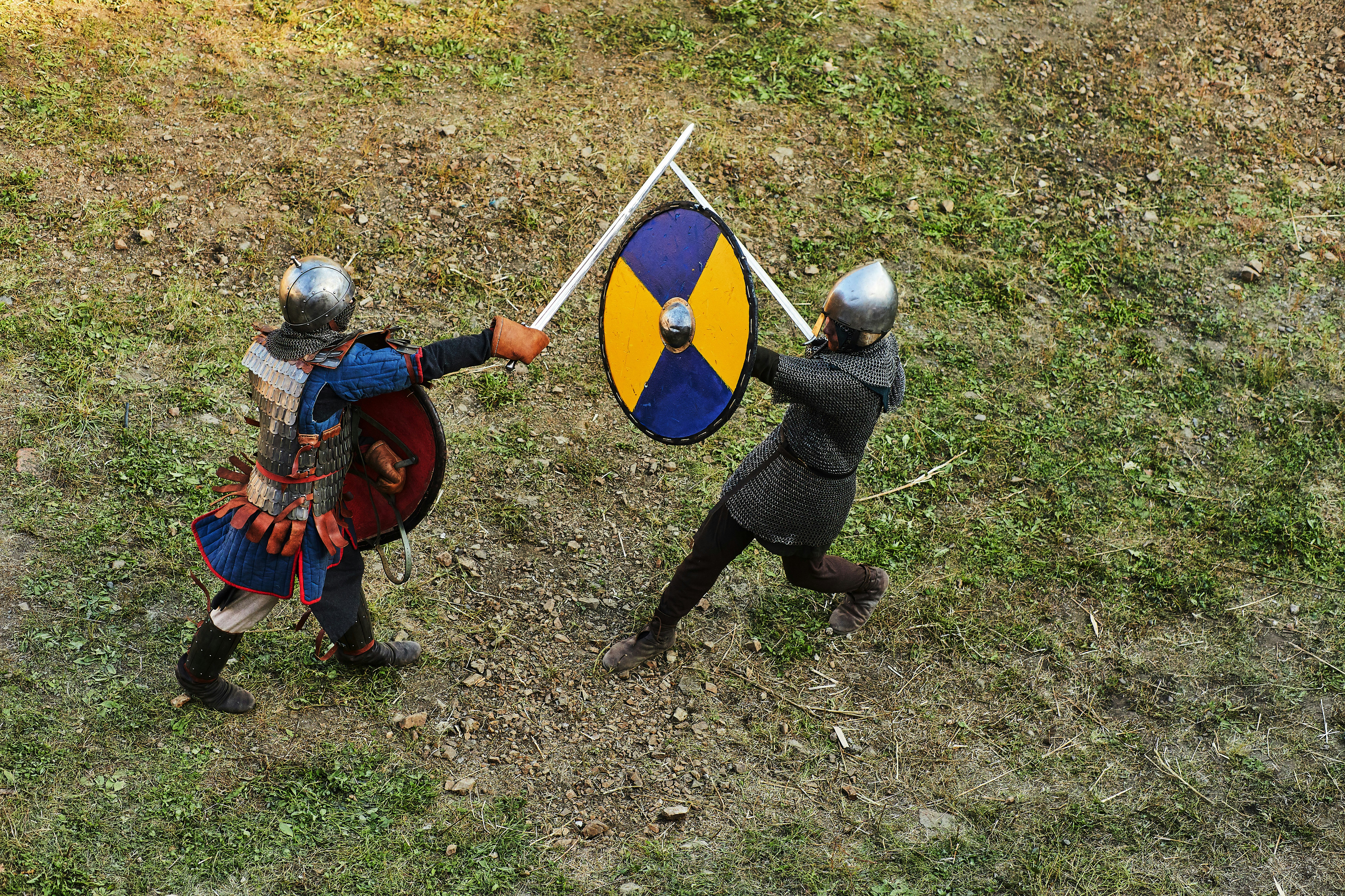 person in blue and red long sleeve shirt and black pants holding blue and black shield