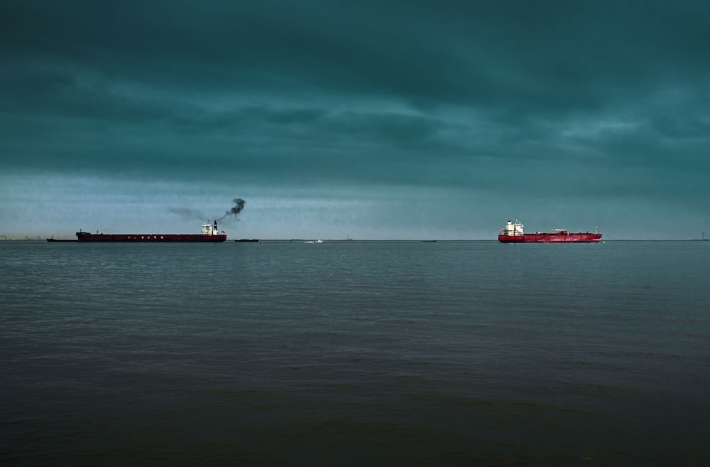 red and white ship on sea under blue sky