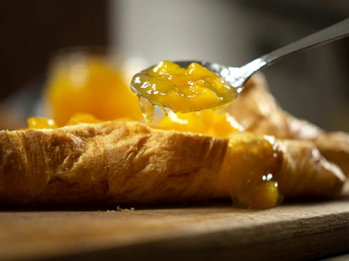 stainless steel spoon on brown bread