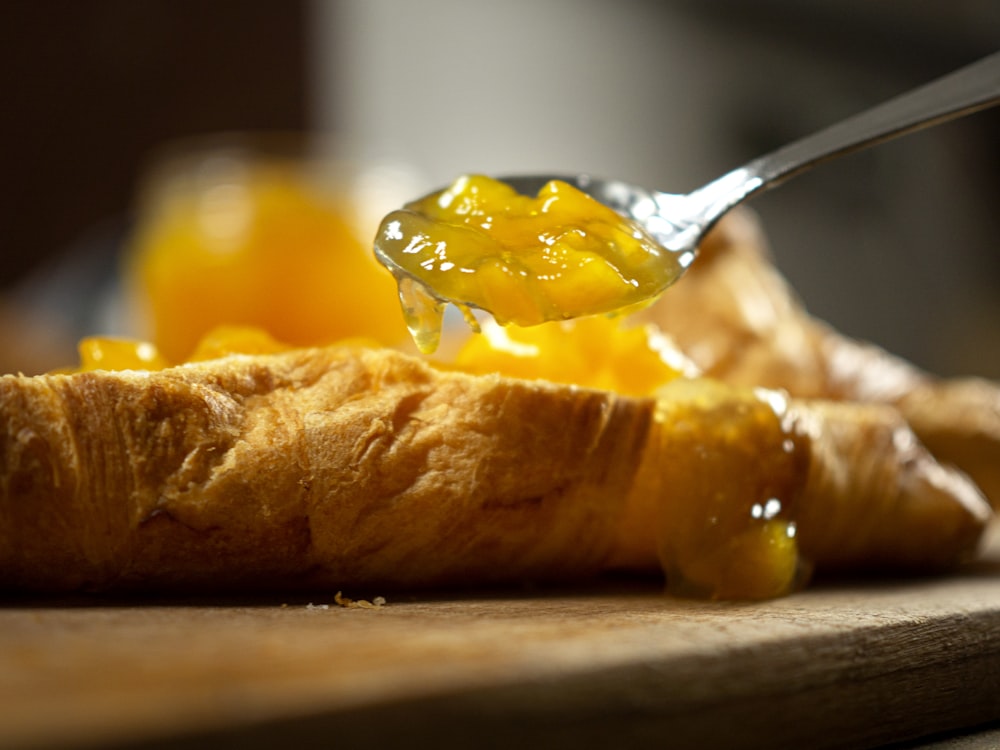 stainless steel spoon on brown bread