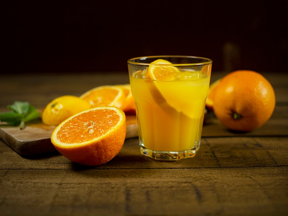 orange juice in clear drinking glass
