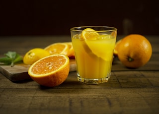 orange juice in clear drinking glass