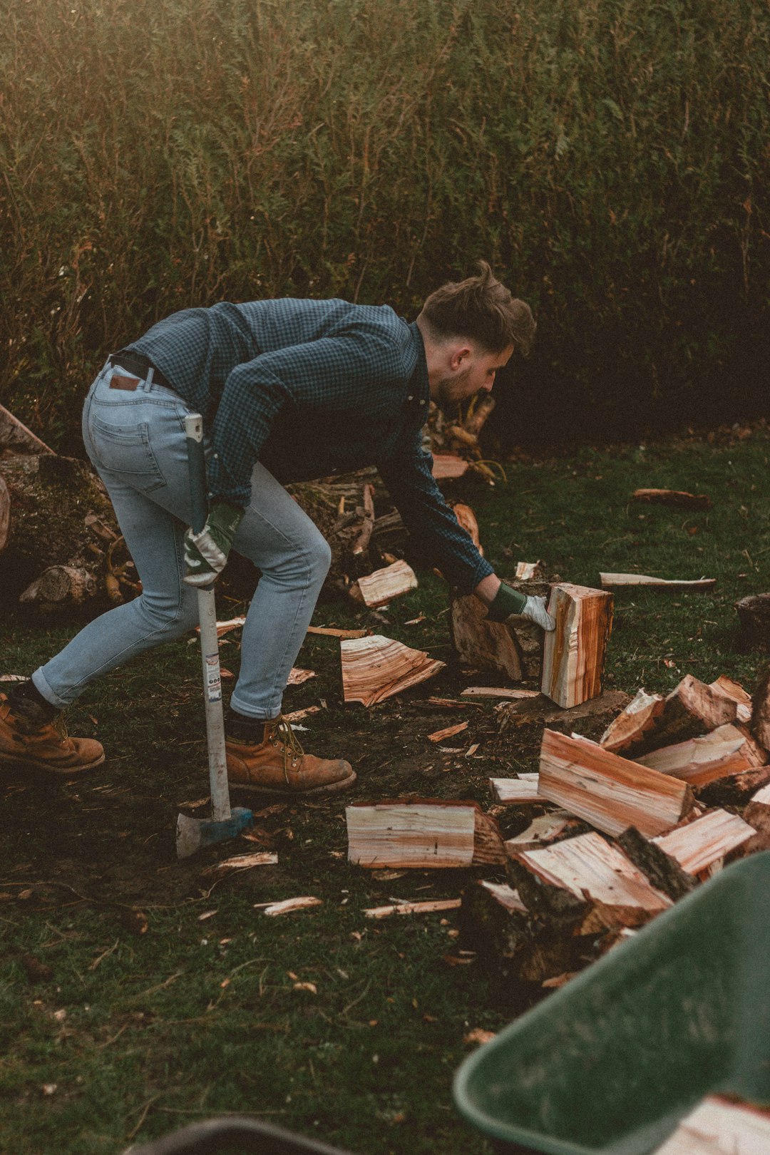 man in blue denim jacket and blue denim jeans holding brown wooden stick