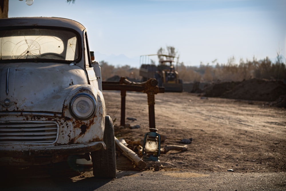 vintage white car on brown soil during daytime