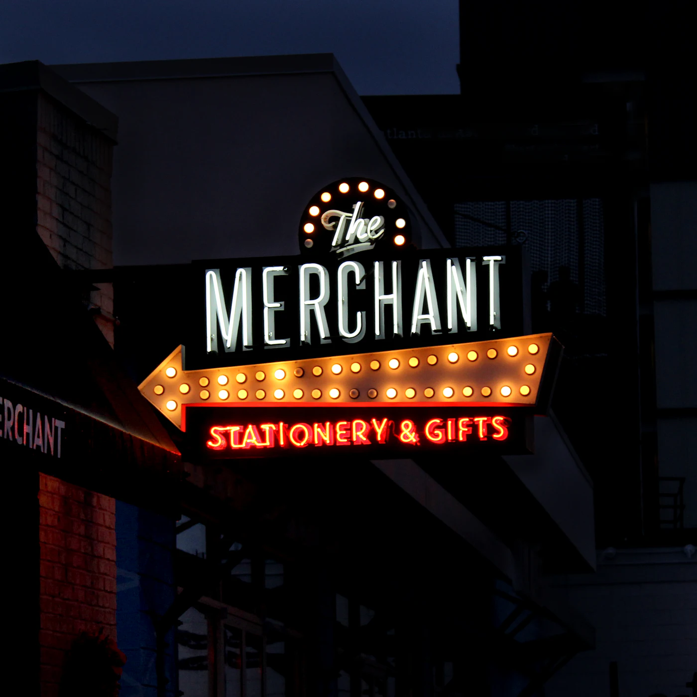 Restaurant storefront with lit sign at night