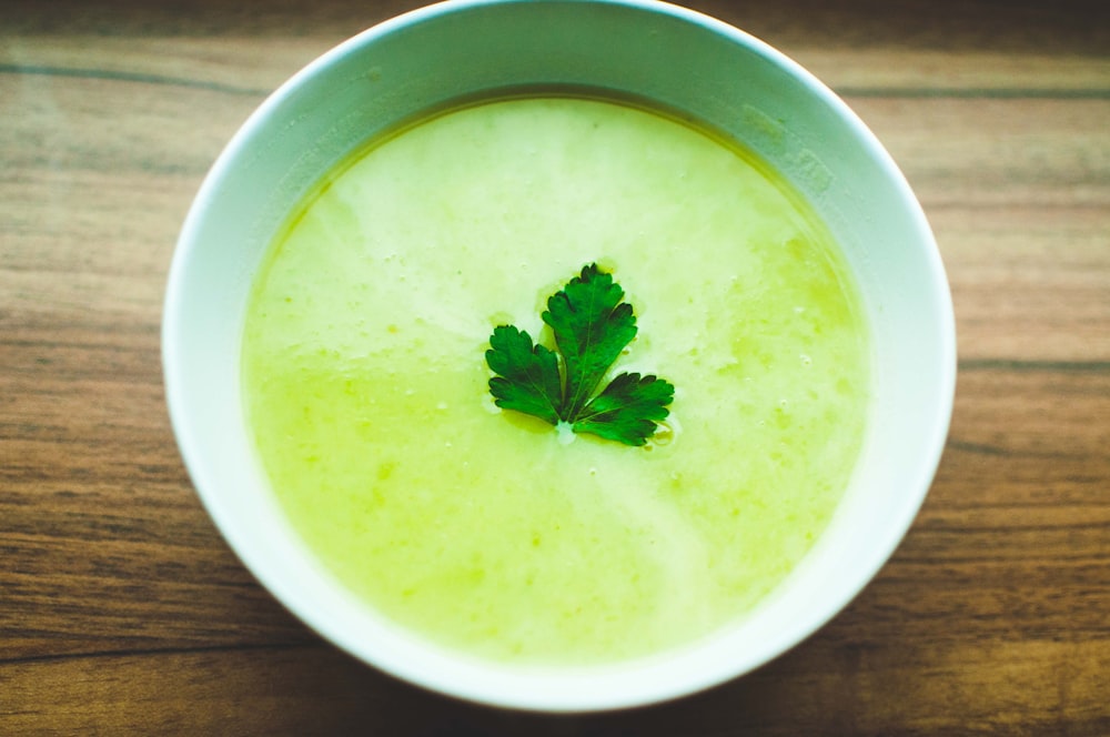 green soup in white ceramic bowl