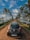 A black Hyundai Eon car is parked on a narrow dirt road flanked by lush green palm trees. A serene water body is on the right side, reflecting the palm trees and clear blue sky, which is dotted with white clouds.