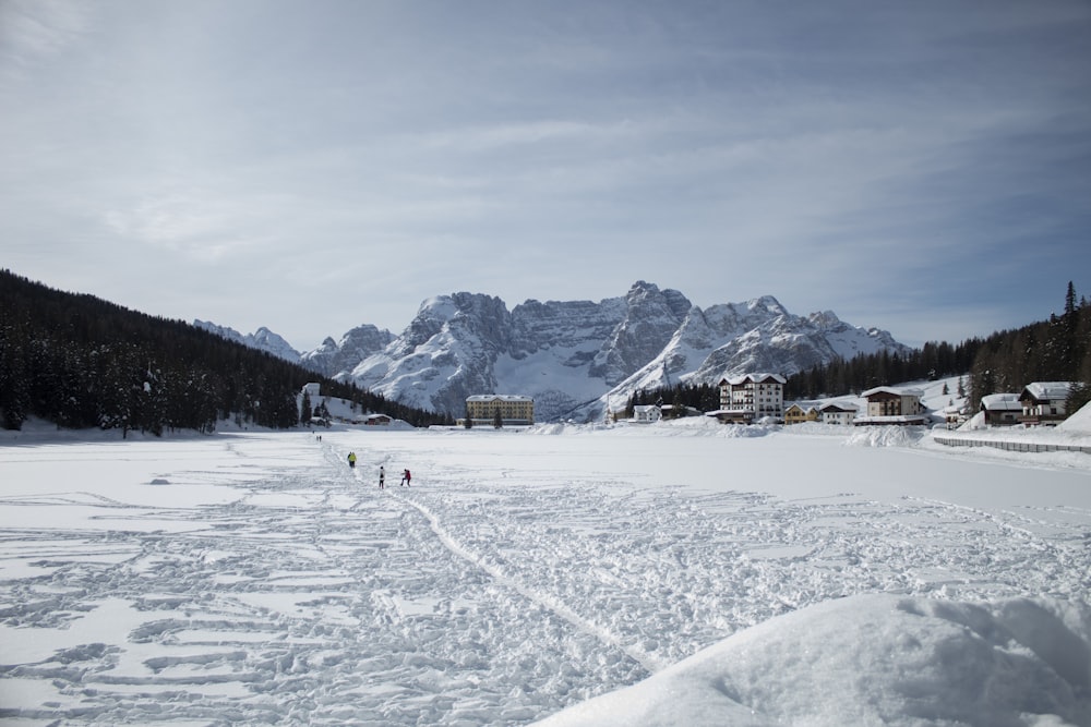 people walking on snow covered field during daytime