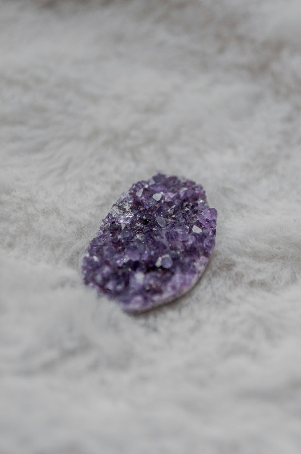purple stone on white textile