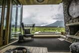 A spacious living area with large windows, showcasing a beautiful view of the surrounding landscape.
