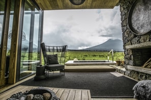 A spacious living area with large windows, showcasing a beautiful view of the surrounding landscape.