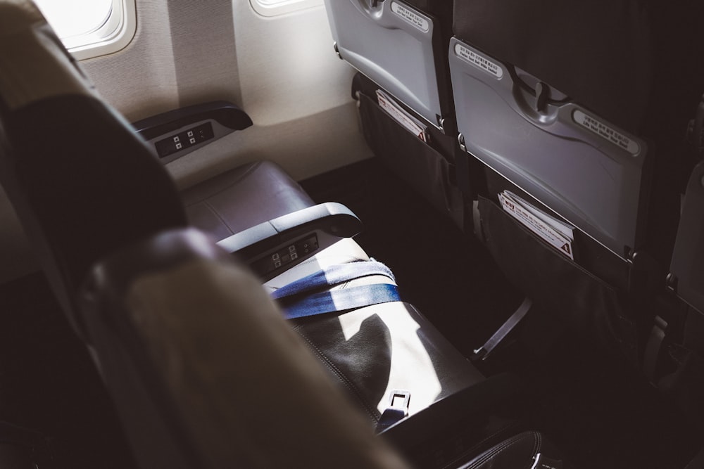 person in blue white and black shorts sitting on car seat