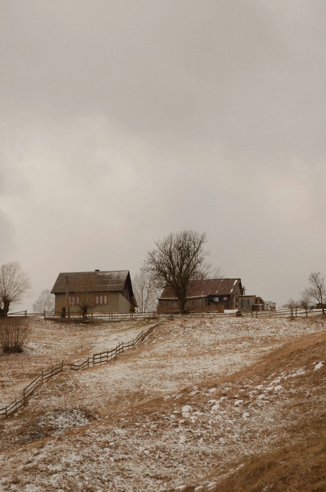 brown house on brown field under white sky during daytime