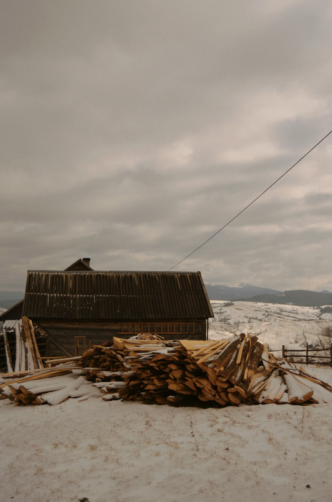 brown wooden house on white snow covered ground during daytime