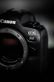 black nikon dslr camera on white table