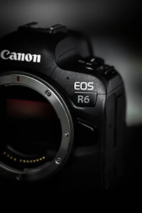 black nikon dslr camera on white table