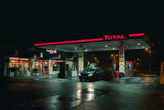 cars parked in front of store during night time