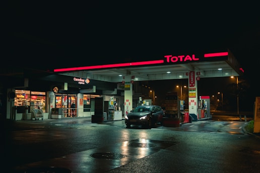 cars parked in front of store during night time