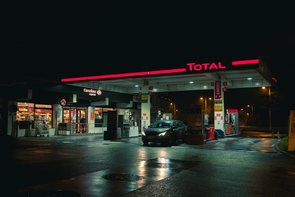 cars parked in front of store during night time