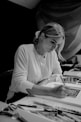 woman in long sleeve shirt writing on notebook