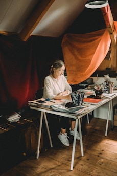 A young drama student in a cozy New York loft, surrounded by scripts and digital screens showing AI tools for acting.