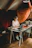 A vibrant portrait of a focused creator working intently at their desk amidst a calming, organized space.