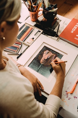 boy in white shirt holding painting